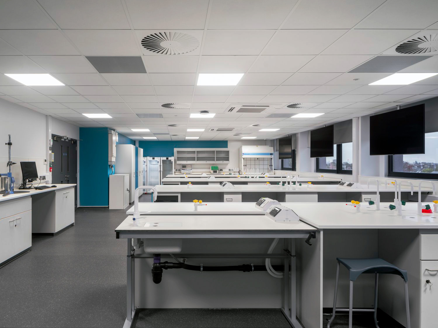 Height adjustable laboratory table with services in high specification London laboratory.